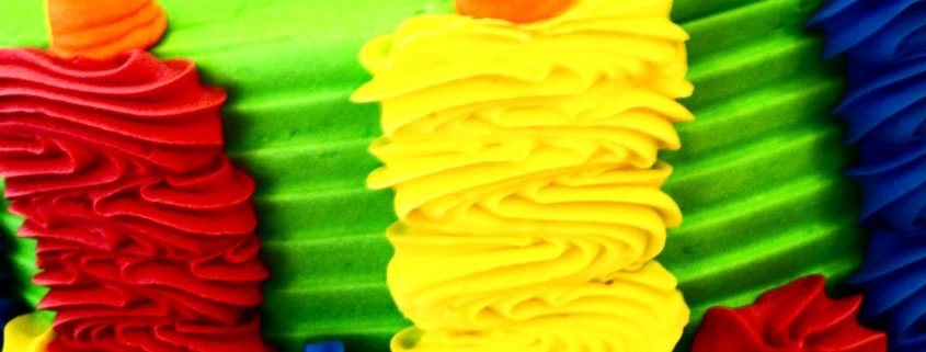 Tasty Pastry Custom Cakes: Round Cake with vivid colored icing in red, yellow, blue, green & orange