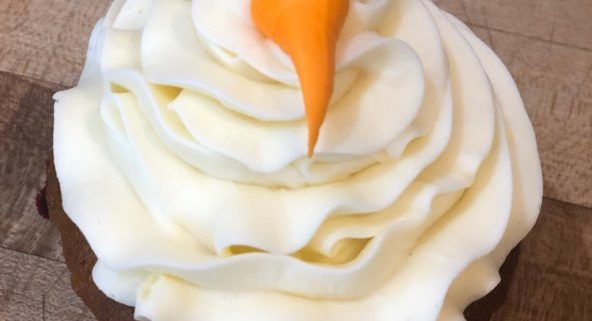 carrot cake cupcake (carrot cake with cream cheese icing) topped off with a carrot made of icing