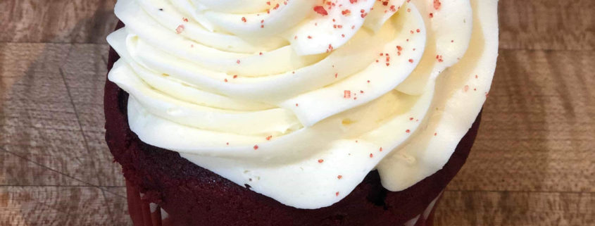 Red Velvet cupcake (velvety red cake with cream cheese frosting and red sprinkles)