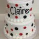 Tasty Pastry Custom Cakes: Two-tier birthday cake with white icing and red/black polka dot decor