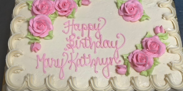 Tasty Pastry Custom Cakes: Birthday sheet cake with white icing and decorated with pink roses and piped white icing